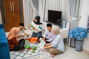 group of young Muslims making and preparing Eid decorations at home