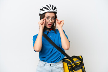 Young Ukrainian woman with thermal backpack isolated on white background with glasses and surprised