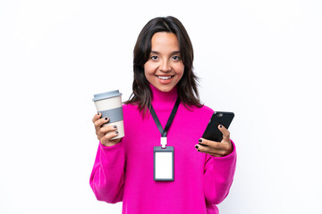 Young hispanic woman with ID card isolated on white background holding coffee to take away and a mobile