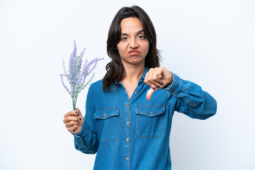 Young hispanic woman holding lavender isolated on white background showing thumb down with negative...