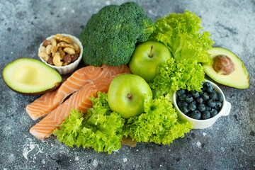 Different vegetables, seeds and fruits on grey table, flat lay.