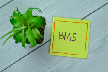 Concept of Bias write on sticky notes isolated on Wooden Table.