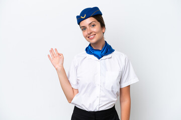 Airplane stewardess caucasian woman isolated on white background saluting with hand with happy expression