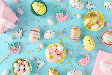 Easter celebration concept. Top view photo of color eggs, easter candy and chocolate sprinkles with...