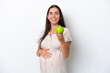 Young caucasian woman isolated on white background pregnant and holding an apple