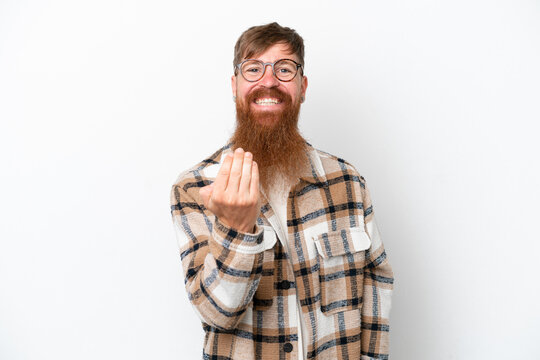 Redhead man with long beard isolated on white background inviting to come with hand. Happy that you came