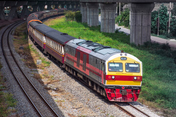 Passenger train by diesel locomotive passed the railway curve. 