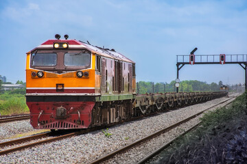 Freight train by diesel locomotive on the railway.