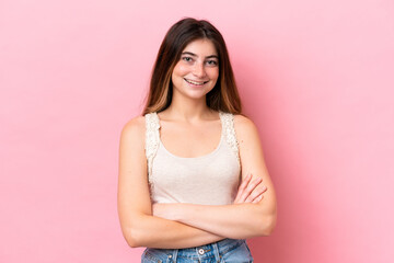 Young caucasian woman isolated on pink background keeping the arms crossed in frontal position