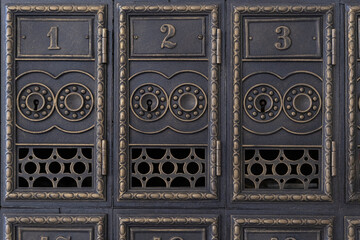Antique mailboxes. Retro metal mailboxes with numbers. Old Post office boxes.