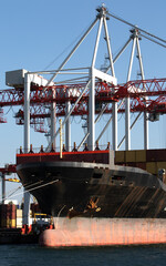 Logistics terminal sends import-export cargo containers to cargo ship in seaport. Industrial...