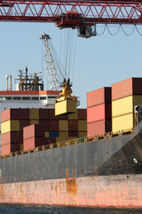 Logistics terminal sends import-export cargo containers to cargo ship in seaport. Industrial...