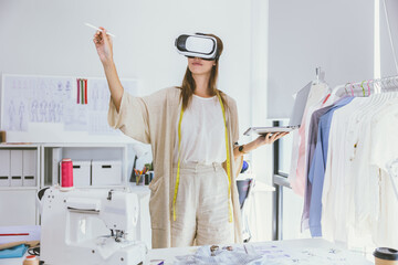 Costume designer using modern VR visual digital design technology in tailor studio