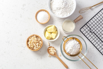 Baking ingredients and cooking utensil on marble kitchen table background