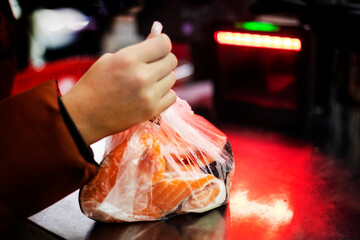 scan slices of salmon steak in a transparent bag at a self-service checkout. Purchase