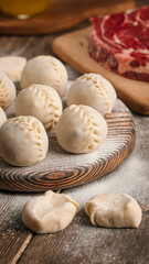 Fototapeta na wymiar Semi-finished manti oriental dumplings on wooden board with flour