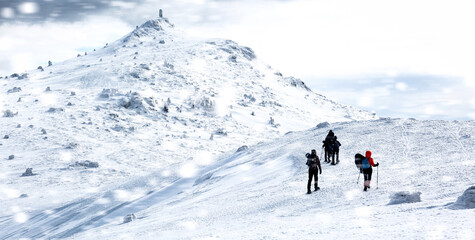 Fototapeta na wymiar Group of people traveling through snow-covered winter Carpathian mountains.