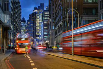 Dusk at the City of London, England, with street traffic light trails and illuminated skyscrapers