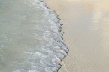 Calm beautiful wave on the white sand stock photo