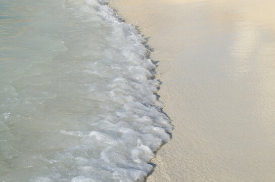 Calm beautiful wave on the white sand stock photo