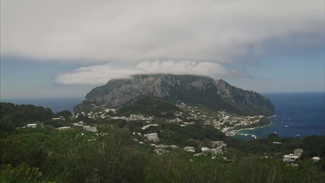 Establishing shot of Capri. Timelapse scenary. Clouds forming over the mountain.