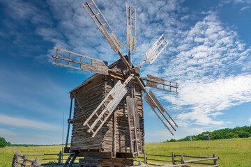 Old windmill on the green meadow