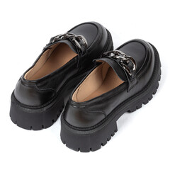 Black women's leather ankle boots on a thick rubber sole decorated with a metal chain on a white background
