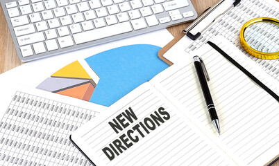NEW DIRECTIONS text on a paper on chart background
