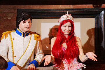 actors in costumes of a prince and a mermaid at a children's party. 