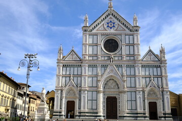 Fototapeta na wymiar Florence church. Piazza Santa Croce in Florence. Church facade with olive trees. 