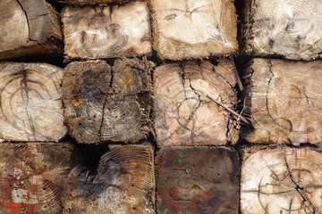Old wooden blocks stacked in a pile, close-up, front view.