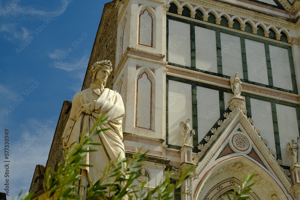 Wall mural dante statue. dante alighieri in florence.statue of dante in piazza santa croce. blue sky background