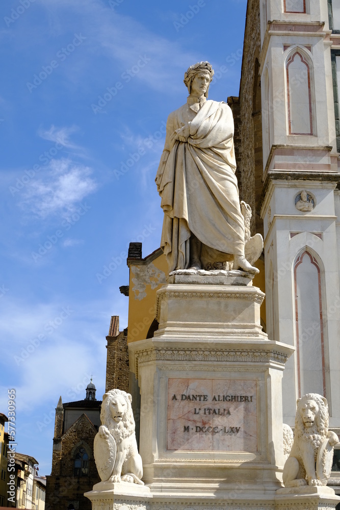 Poster dante alighieri. dante alighieri in florence.statue of dante in piazza santa croce. blue sky backgro