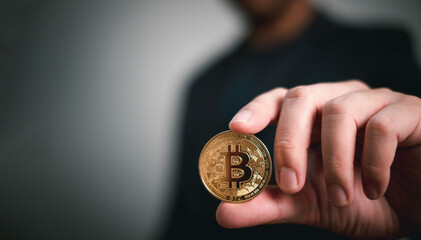 gold bitcoin is holding by businessman, represented cryptocurrency investment on internet for store of wealth or speculation for more income and wealth of investor