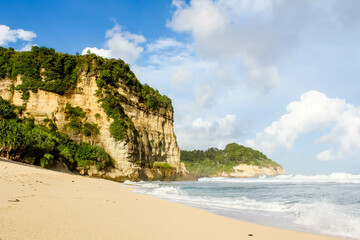 Fototapeta premium Tropical paradise beach with white sand and cliffs and blue sky with clouds on Sunny day. Summer tropical landscape, panoramic view. travel tourism wide panorama background concept. 