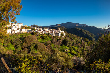 Fototapeta na wymiar Exploring the streets of the beautiful white village of Genalguacil in Andalusia Spain at sunset during the springtime