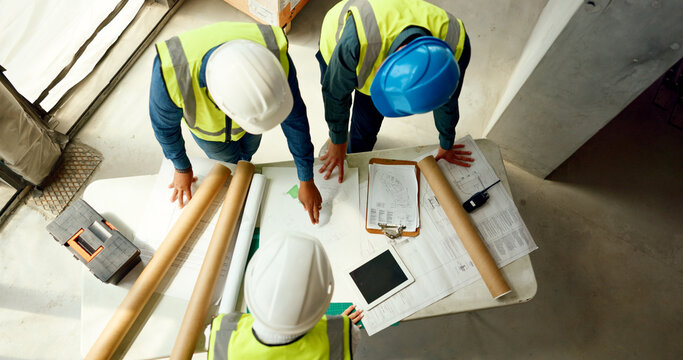 Top view, team and construction for blueprint building, collaboration or talking for business strategy or discussion. Top view, teamwork or engineer or architect planning, contractor or group project