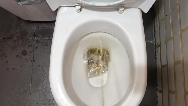 urine stream in toilet clogging with napkins and paper. clogging in the plumbing due to improper operation.