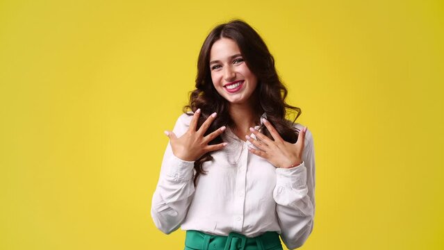 4k video of one girl who is embarrassed to receive compliments over yellow background.
