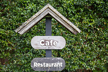 Wooden signs directing to cafes and restaurants.