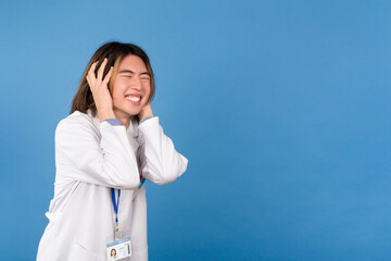 Portrait of a Young Asian Doctor Covering His Ears with His Hands in Studio