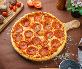 American pizza with pepperoni, mozzarella and tomato sauce. Pizza on a table,
