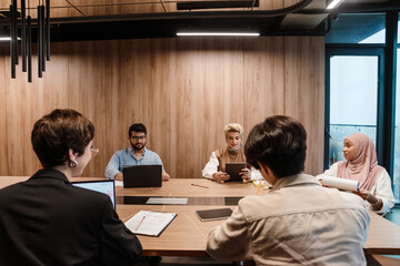 Team discussing project while sitting in conference room