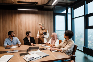 Female manager addressing her team during meeting in conference room