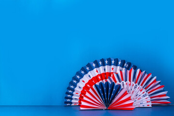 Happy Labor Day, Presidents Day, Fourth of July Independent Day, Memorial day, Columbus day background. Blue background with USA flag color paper fans and decorations, party accessories