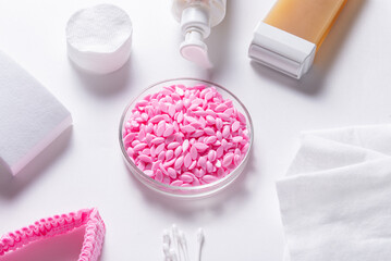 Hot film wax for depilation procedure on white background