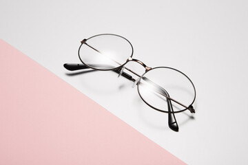 Eyeglasses with round rim for men or women lie diagonally.