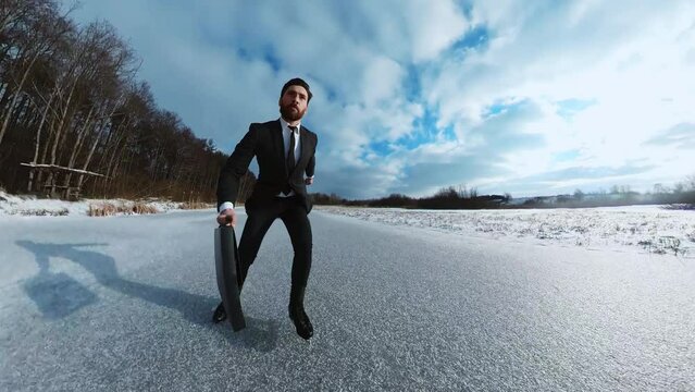 Shooting of attractive entrepreneur with black suitcase hurries to business meeting. Portrait of man ice skating on frozen asphalt outdoors. Scared guy stopped before obstacle. Sign, gesture