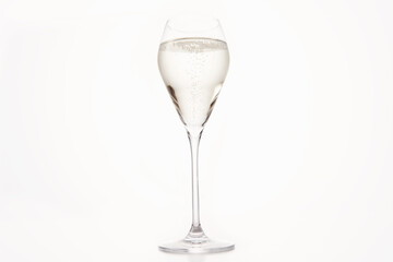 Sparkling wine in stemmed glass holiday template. Bottle of champagne on white isolated.