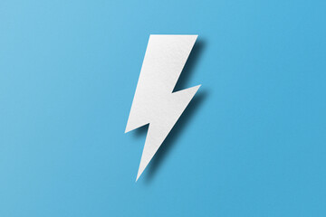 Paper cut lightning shape, lightning with light and shadow. Placed on a light blue paper background.